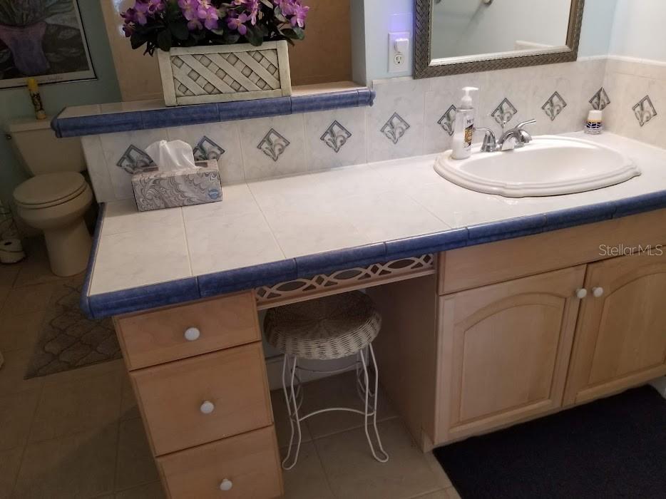 13650 Gulf Boulevard, Unit 304 Madeira Beach, FL 33708 - Photo 43 of 63 a bathroom with a sink and a mirror