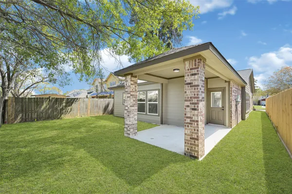 a view of a house with a yard and pathway