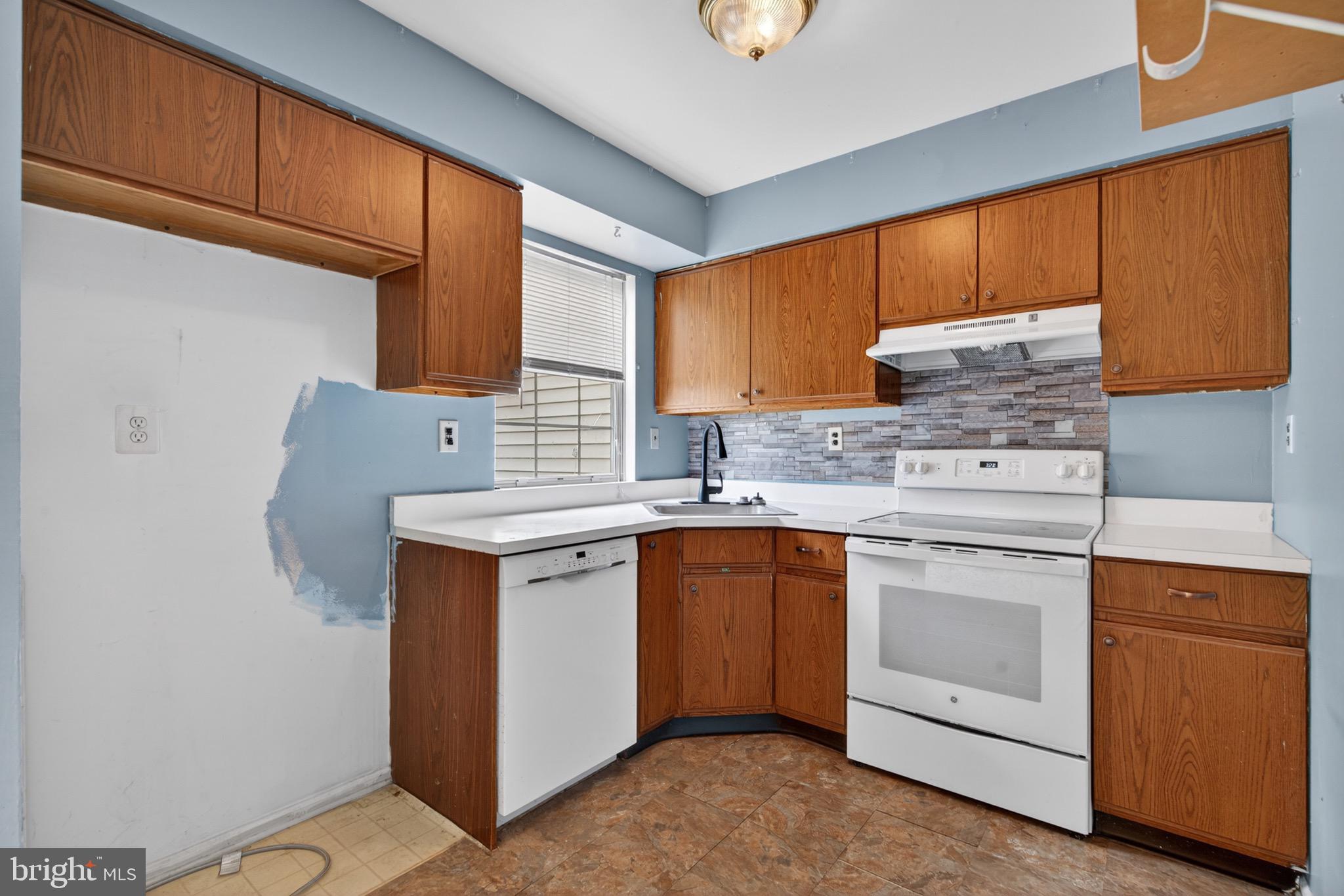 228 Goshen Road Schwenksville, PA 19473 - Photo 6 of 14 a kitchen with granite countertop cabinets stainless steel appliances and a sink