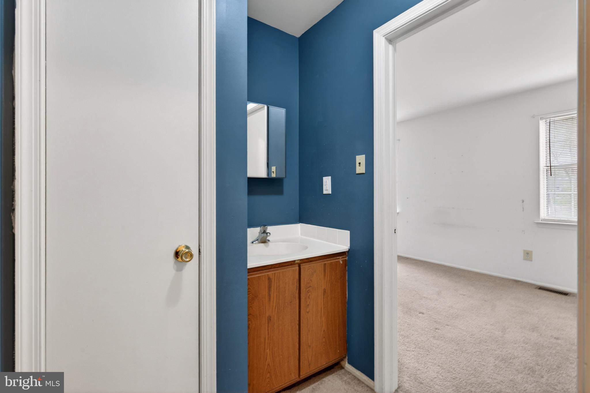228 Goshen Road Schwenksville, PA 19473 - Photo 10 of 14 a bathroom with a granite countertop sink and washing machine