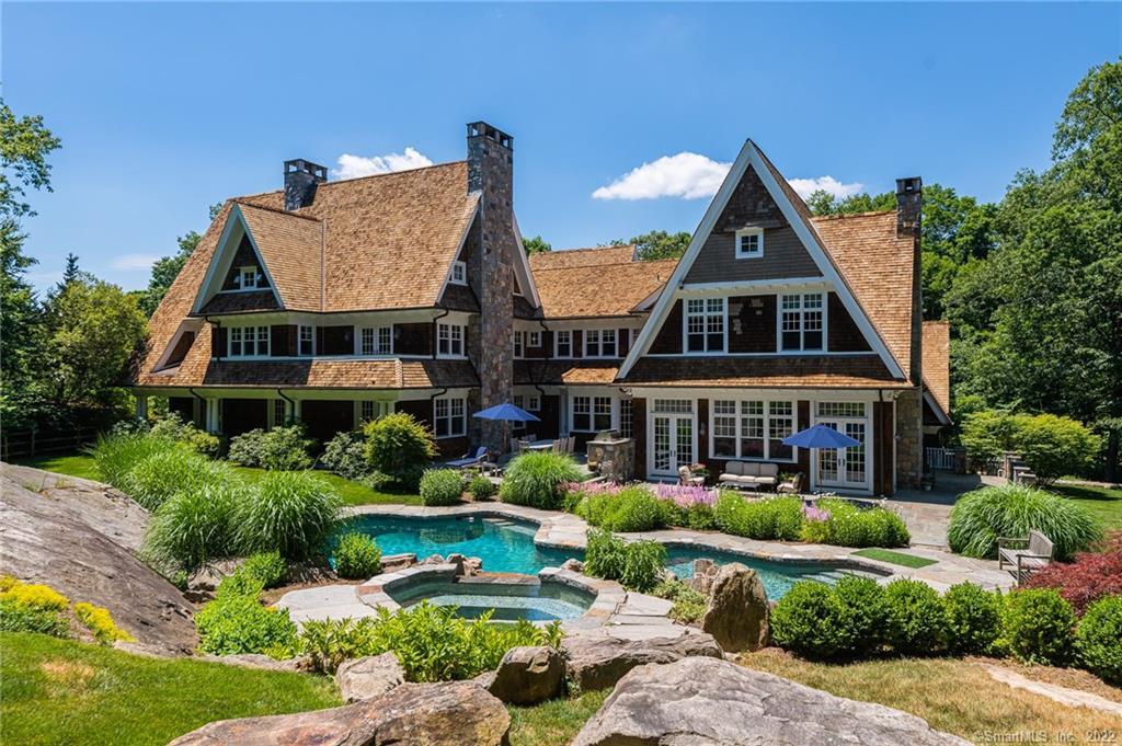 54 Rock Maple Road Greenwich, CT 06830 - Photo 1 of 1 a front view of residential houses with yard and green space