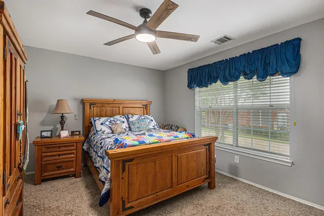 a bedroom with a bed and a window