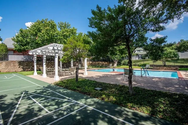 a view of a backyard with large trees