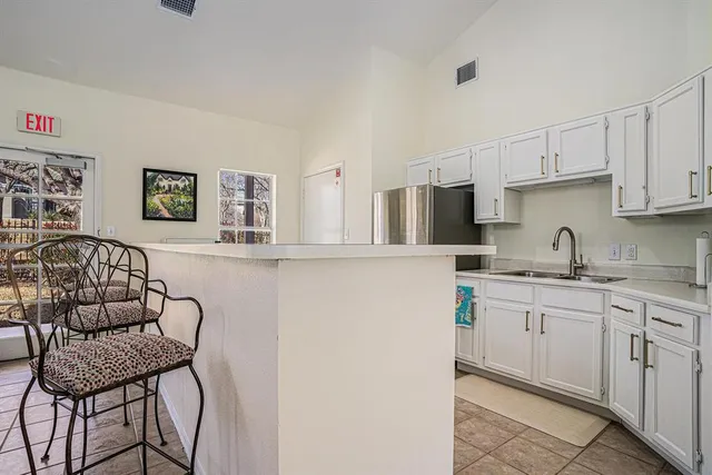 a kitchen with stainless steel appliances a white cabinets and a refrigerator