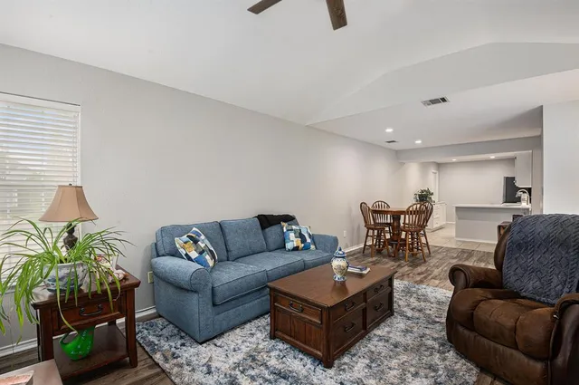 a living room with furniture and a potted plant