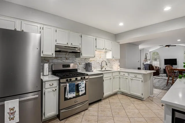 a kitchen with cabinets appliances and a counter