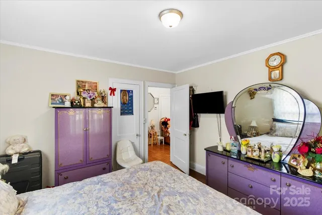 a bedroom with a bed and a dresser in it