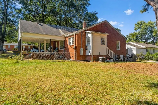a front view of house with a garden