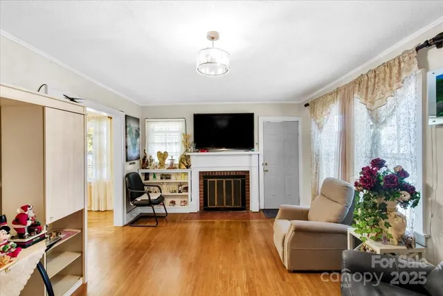 a living room with furniture fireplace and flat screen tv