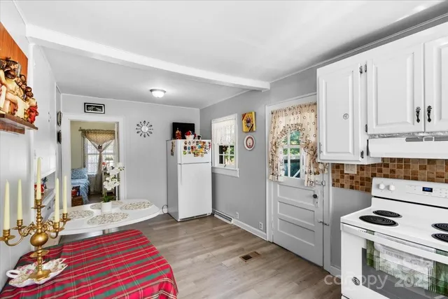 a kitchen with a stove a refrigerator and cabinets