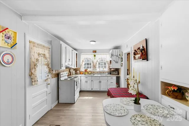 a kitchen with stainless steel appliances granite countertop a refrigerator and stove top oven