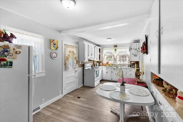 a kitchen with stainless steel appliances granite countertop a refrigerator and stove
