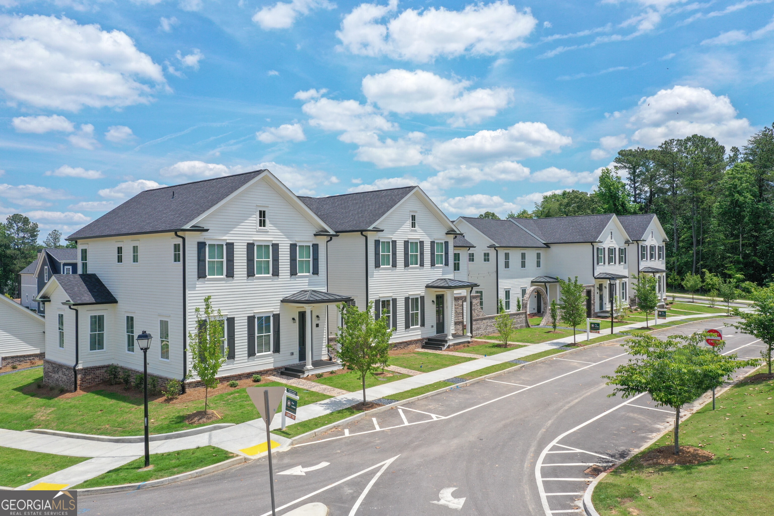 a front view of a house with a yard table and chairs