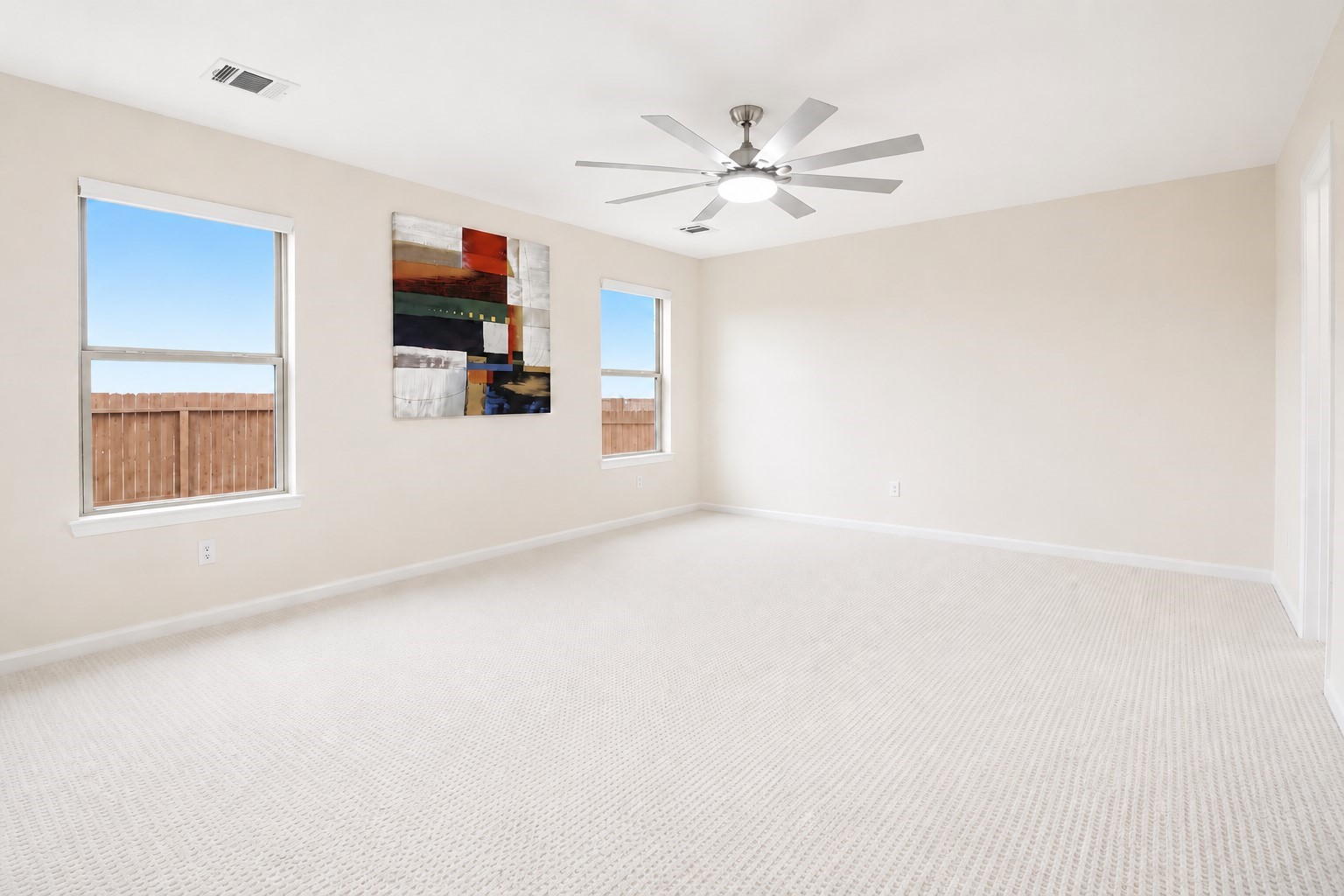 5612 Rainflower Terrace Lane Spring, TX 77389 - Photo 19 of 50 a view of a livingroom with wooden floor and a ceiling fan