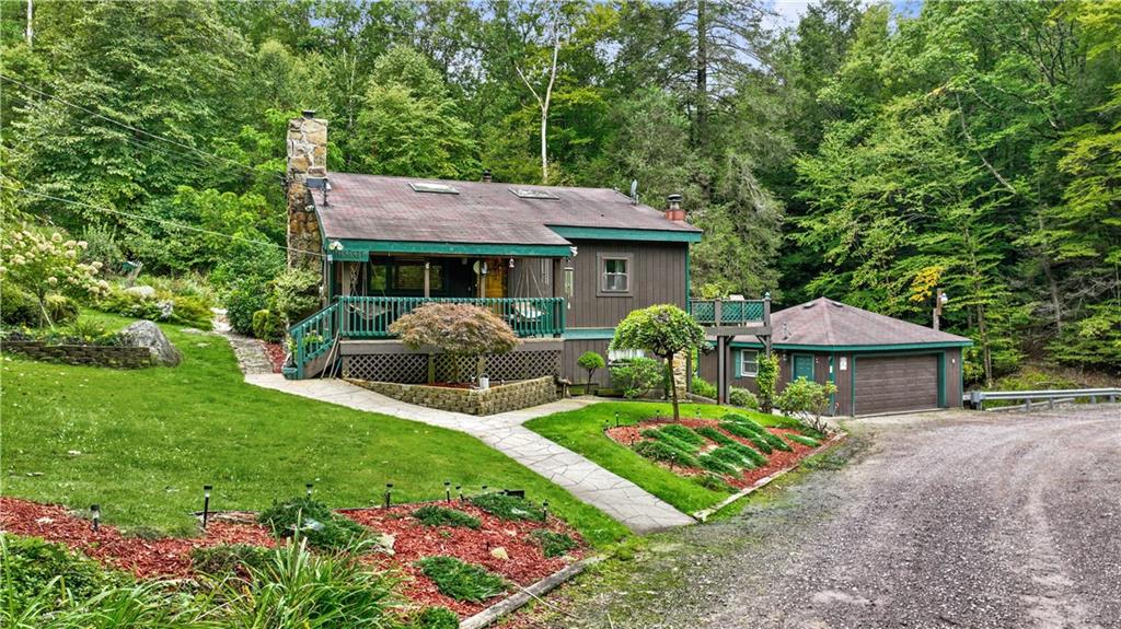 109 Fire Tower Road Confluence, PA 15424 - Photo 1 of 29 a front view of a house with garden