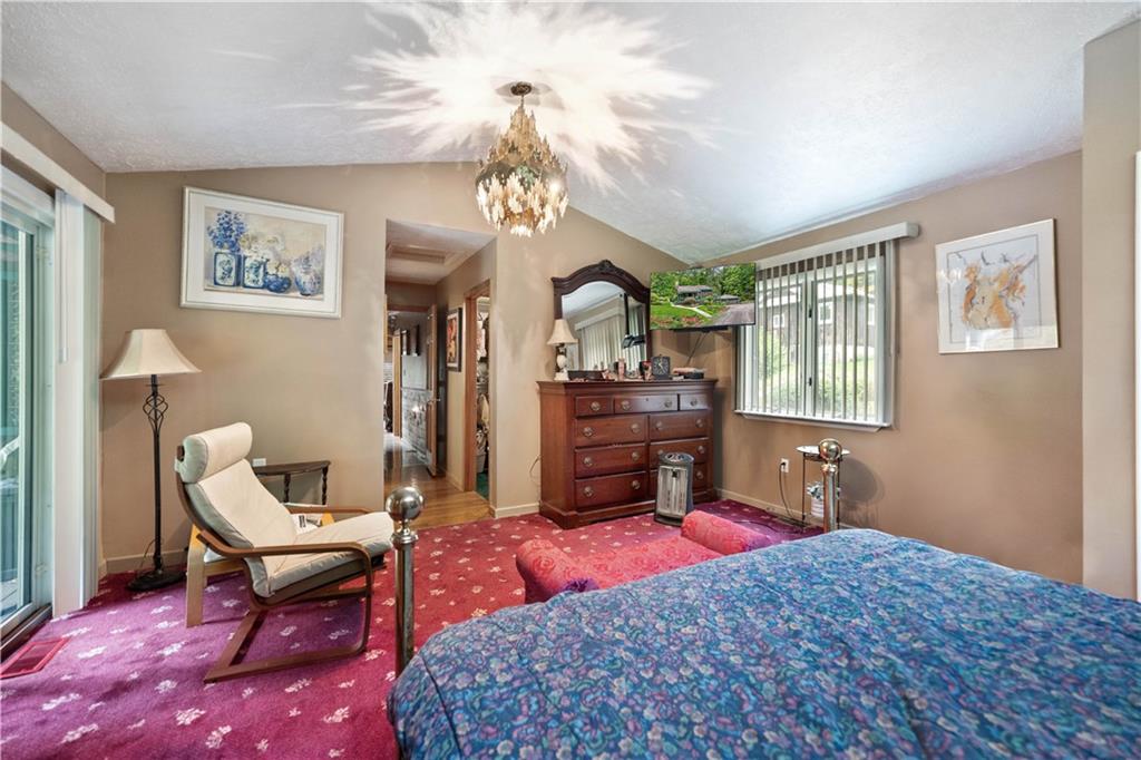 109 Fire Tower Road Confluence, PA 15424 - Photo 18 of 29 a bedroom with a bed and a chandelier