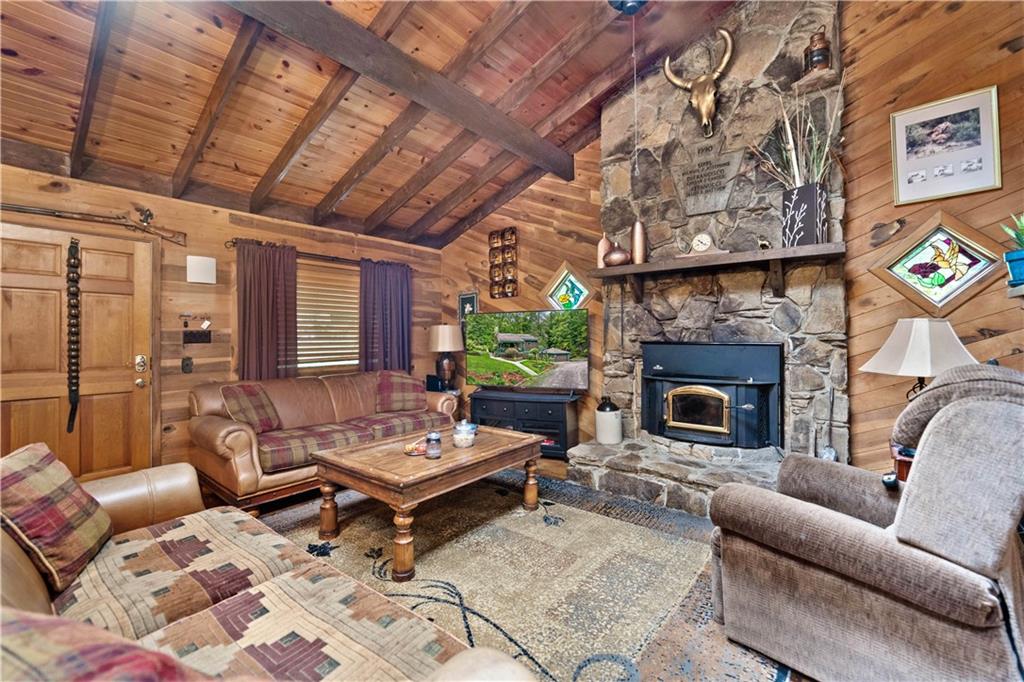 109 Fire Tower Road Confluence, PA 15424 - Photo 6 of 29 a living room with furniture a fireplace and a table
