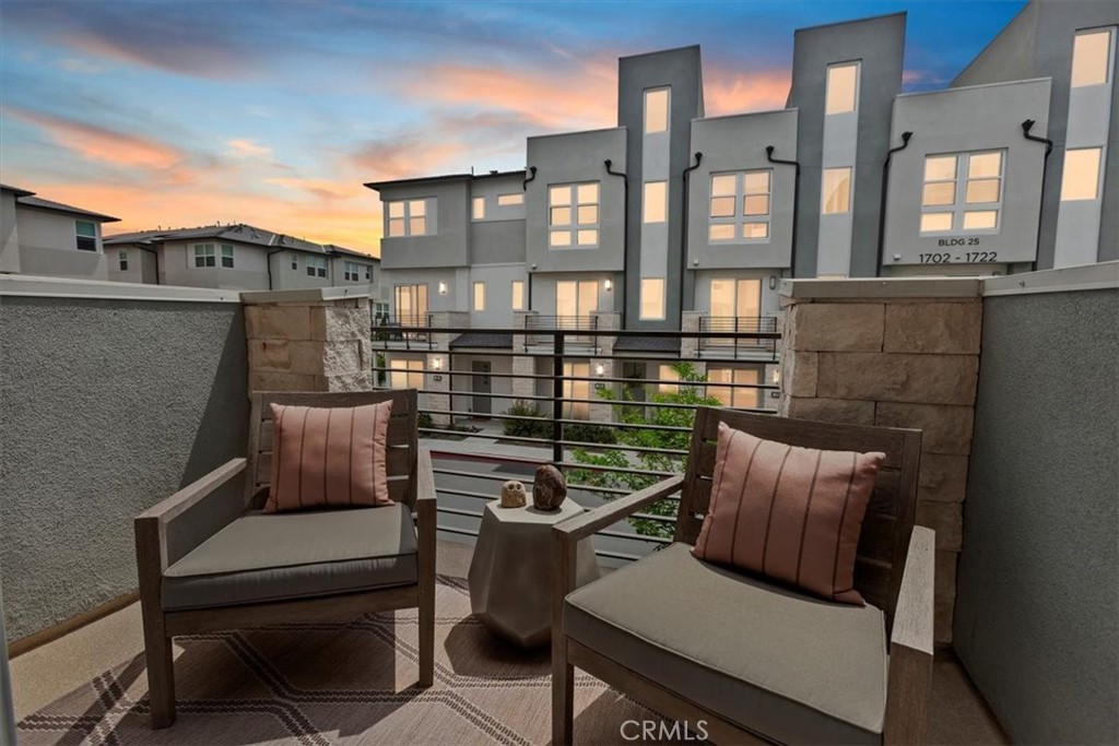 1810 West Bushell Street Anaheim, CA 92805 - Photo 3 of 36 a view of a balcony with two chairs and a potted plant