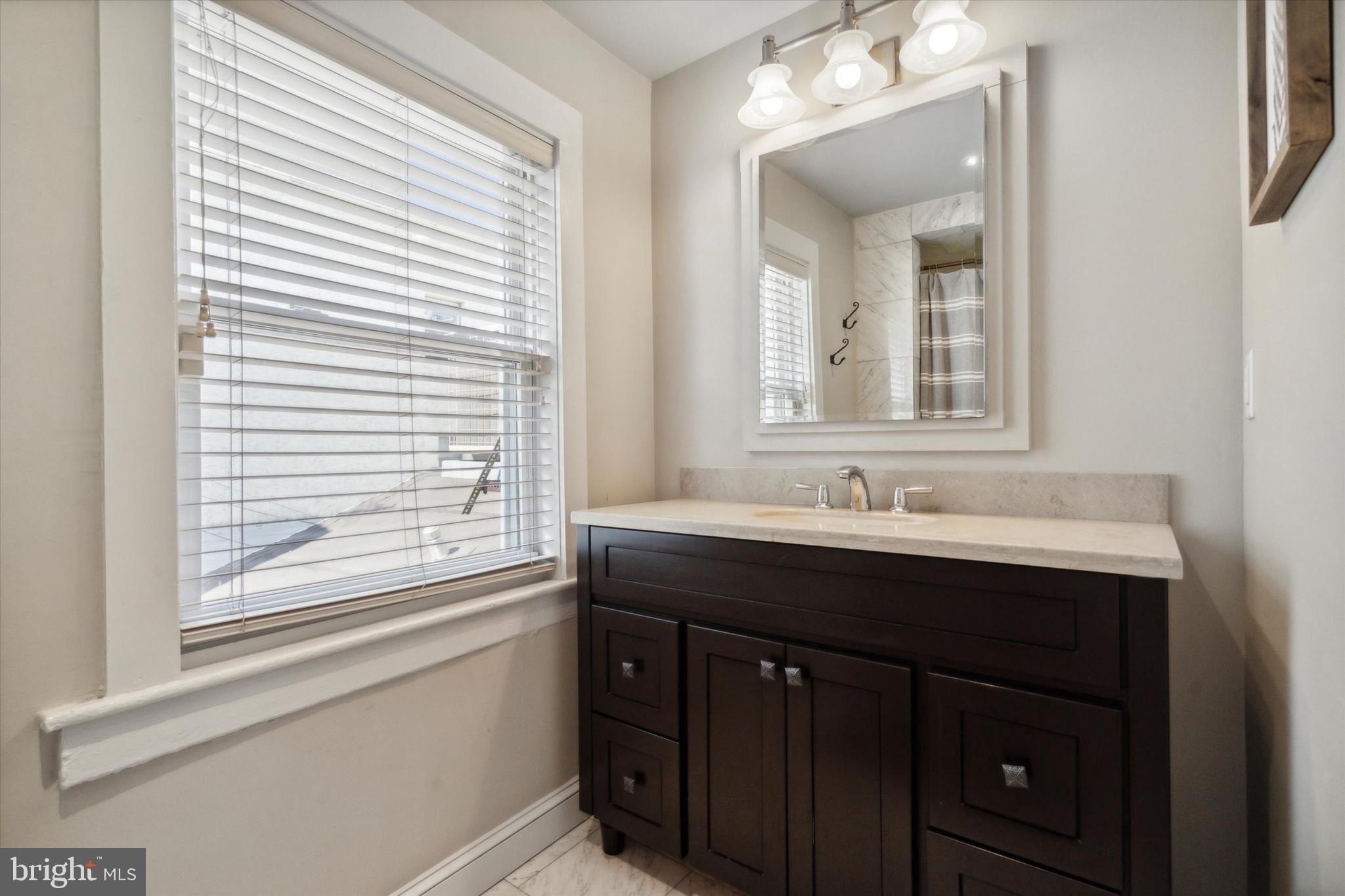 1640 Waverly Street Philadelphia, PA 19146 - Photo 11 of 16 a bathroom with a sink and a mirror