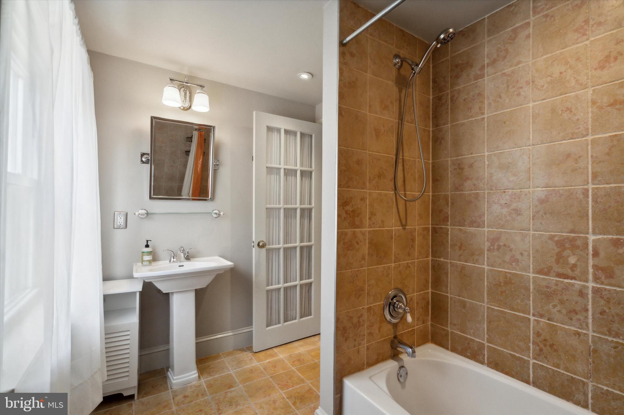 1640 Waverly Street Philadelphia, PA 19146 - Photo 14 of 16 a bathroom with a sink toilet and shower