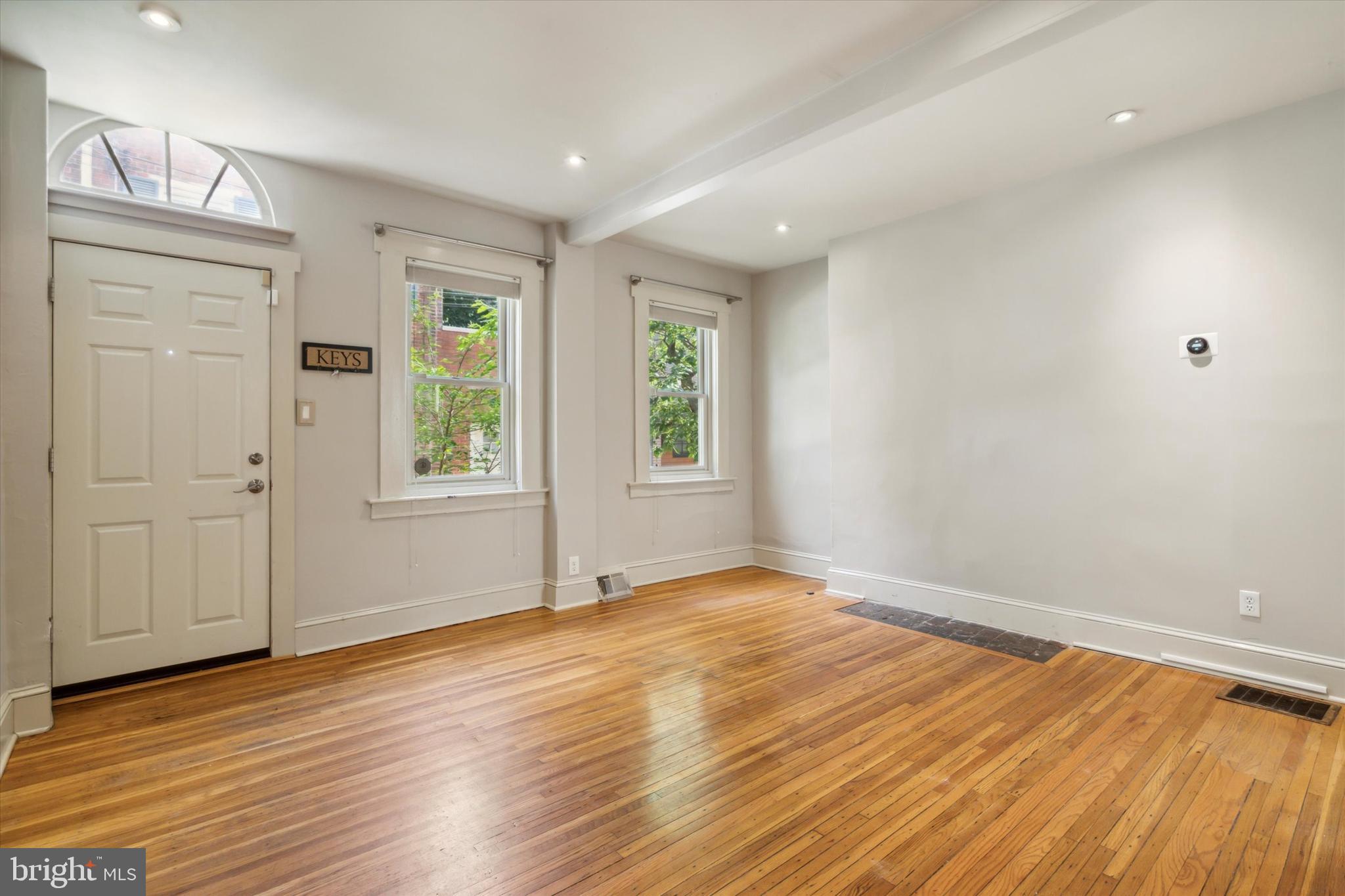 1640 Waverly Street Philadelphia, PA 19146 - Photo 2 of 16 a view of an empty room with wooden floor and a window