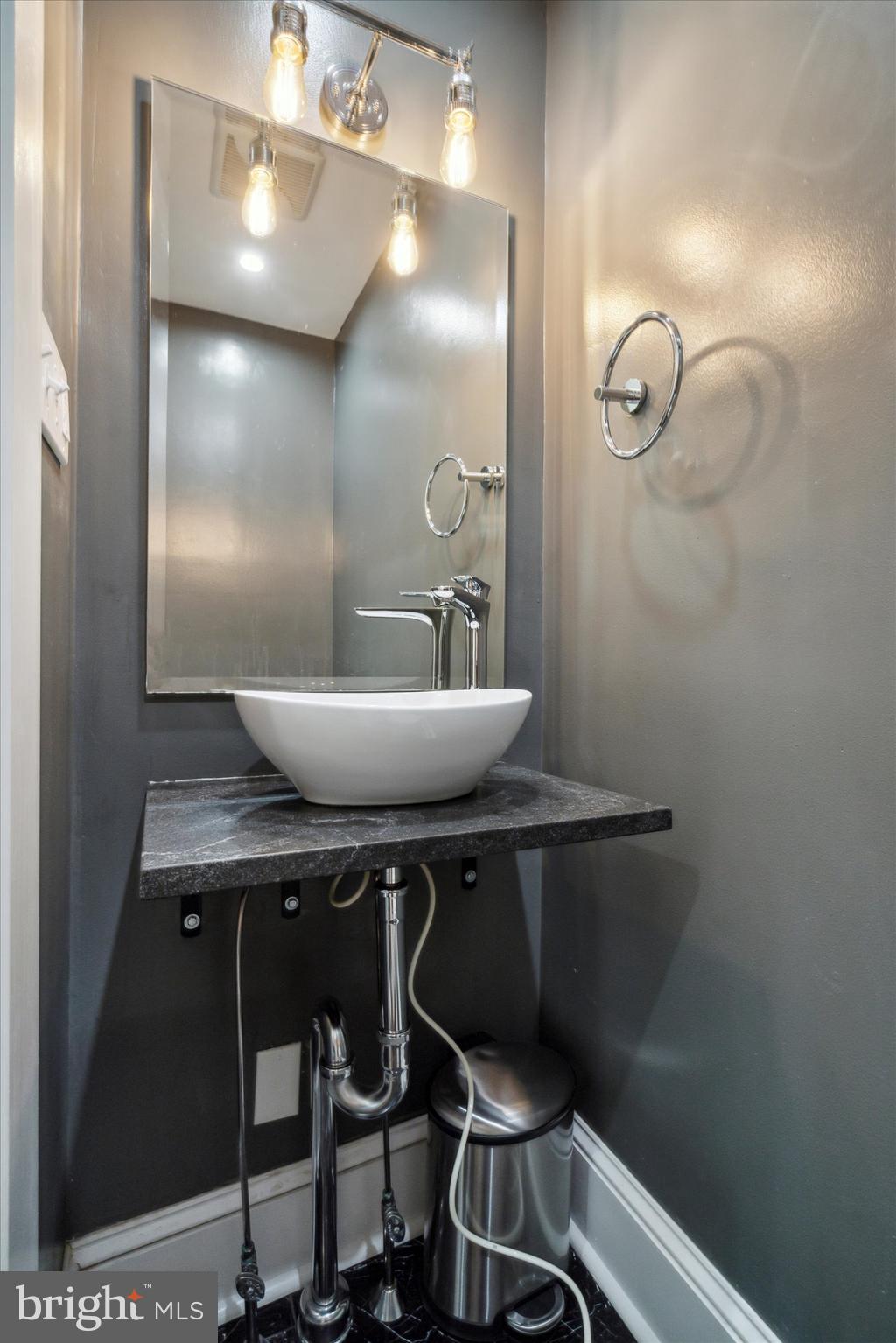 1640 Waverly Street Philadelphia, PA 19146 - Photo 4 of 16 a bathroom with a sink a toilet and a mirror