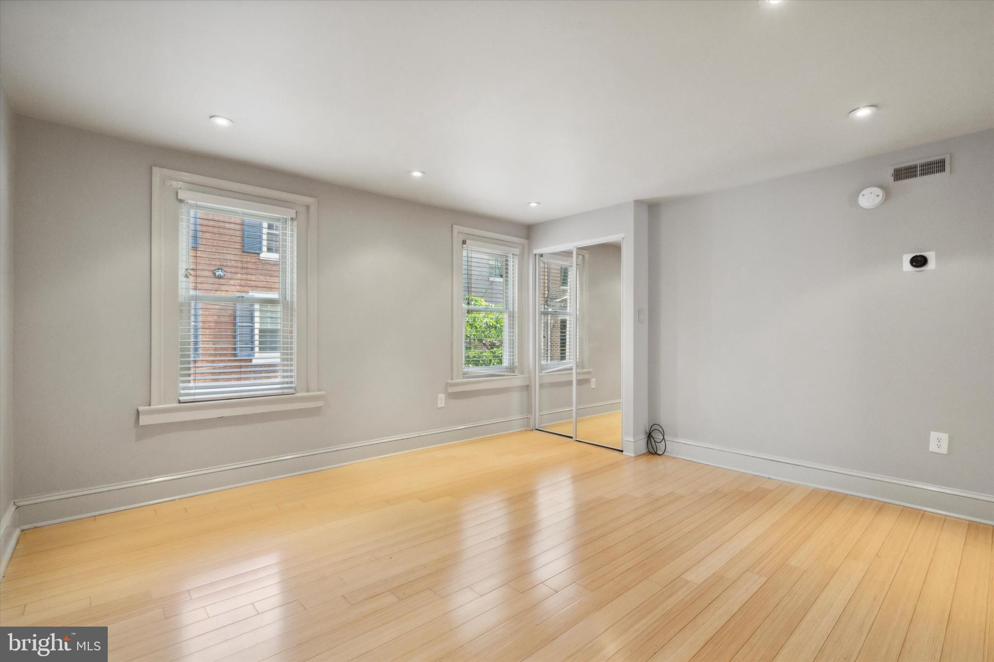 1640 Waverly Street Philadelphia, PA 19146 - Photo 8 of 16 a view of an empty room with wooden floor and a window
