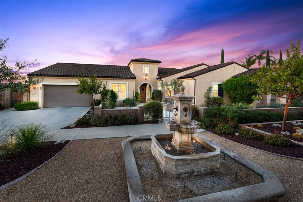 a house view with a sitting space fire pit and outdoor space