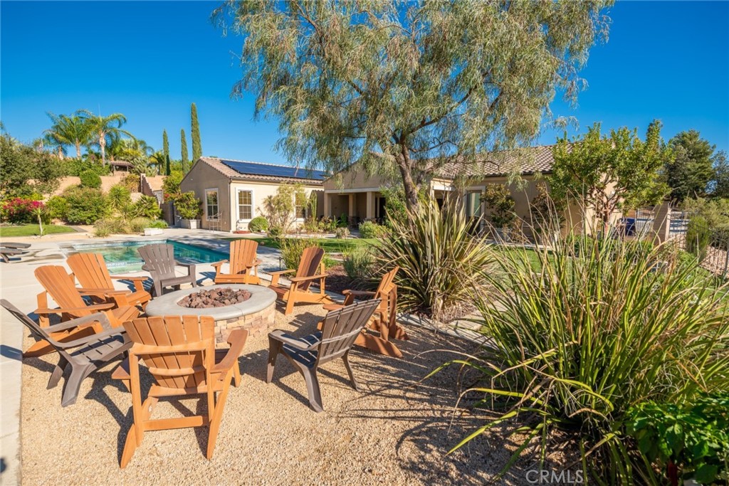 845 Alpine Meadows Lane Riverside, CA 92506 - Photo 36 of 57 a view of a chairs and table in a backyard