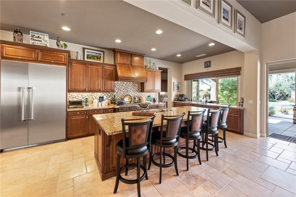 845 Alpine Meadows Lane Riverside, CA 92506 - Photo 40 of 57 a kitchen with stainless steel appliances kitchen island granite countertop a sink and cabinets