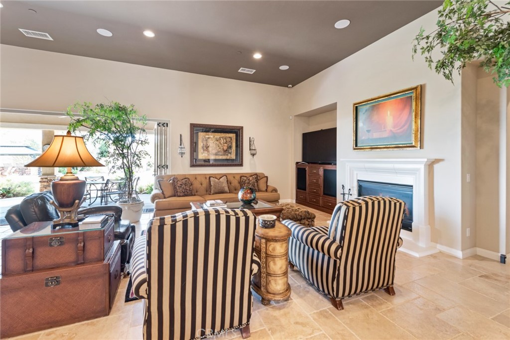 845 Alpine Meadows Lane Riverside, CA 92506 - Photo 43 of 57 a bedroom with furniture a flat screen tv and a fireplace