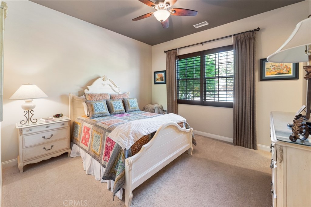 845 Alpine Meadows Lane Riverside, CA 92506 - Photo 49 of 57 a spacious bedroom with a bed and a chandelier