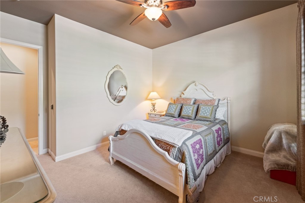 845 Alpine Meadows Lane Riverside, CA 92506 - Photo 50 of 57 a bed room with a bed and a chandelier