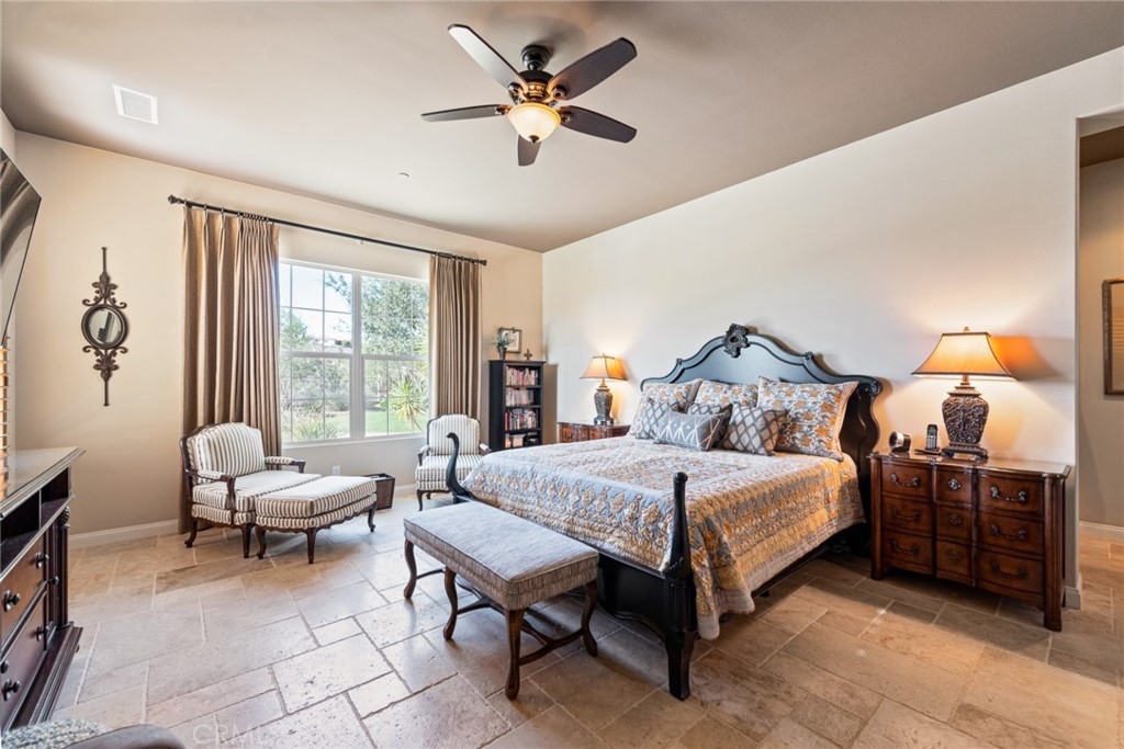 845 Alpine Meadows Lane Riverside, CA 92506 - Photo 56 of 57 a bedroom with a bed and a chandelier