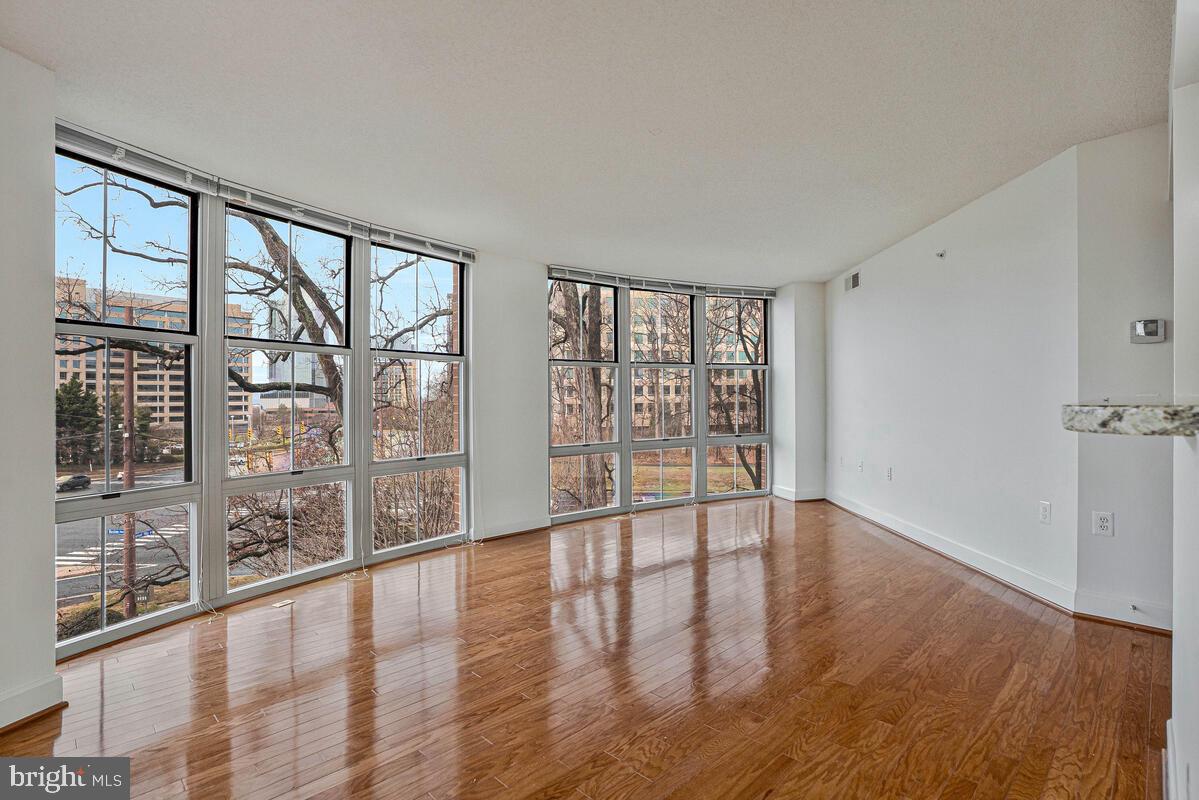 11800 Sunset Hills Road, Unit 514 Reston, VA 20190 - Photo 33 of 57 wooden floor in an empty room with a window