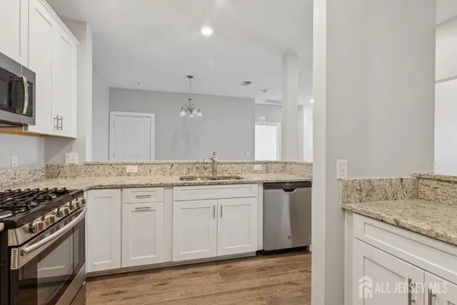 a kitchen with stainless steel appliances granite countertop a stove and a sink