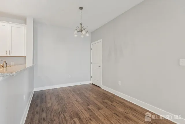 a view of a room with wooden floor and cabinetry