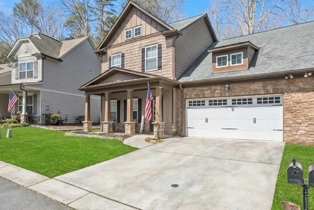 a front view of a house with a yard and garage