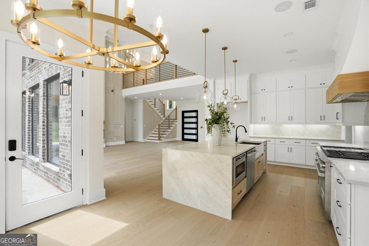 1557 Whitley Road Dacula, GA 30019 - Photo 15 of 46 a kitchen that has a lot of white cabinets