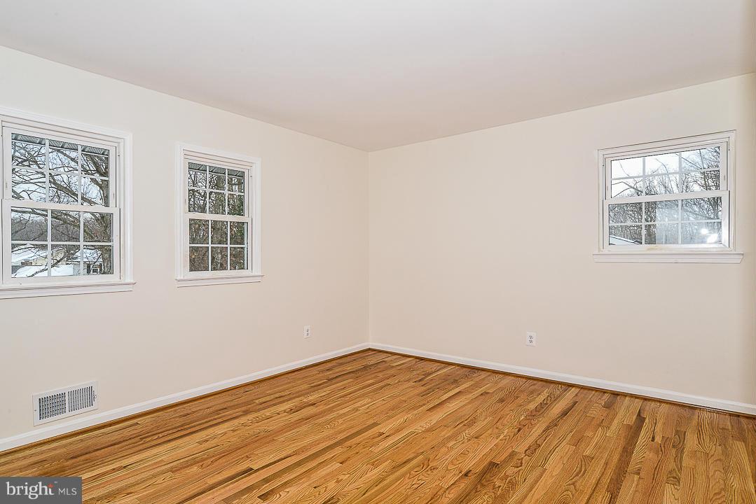 6106 Roxbury Avenue Springfield, VA 22152 - Photo 14 of 29 a view of empty room with wooden floor and fan