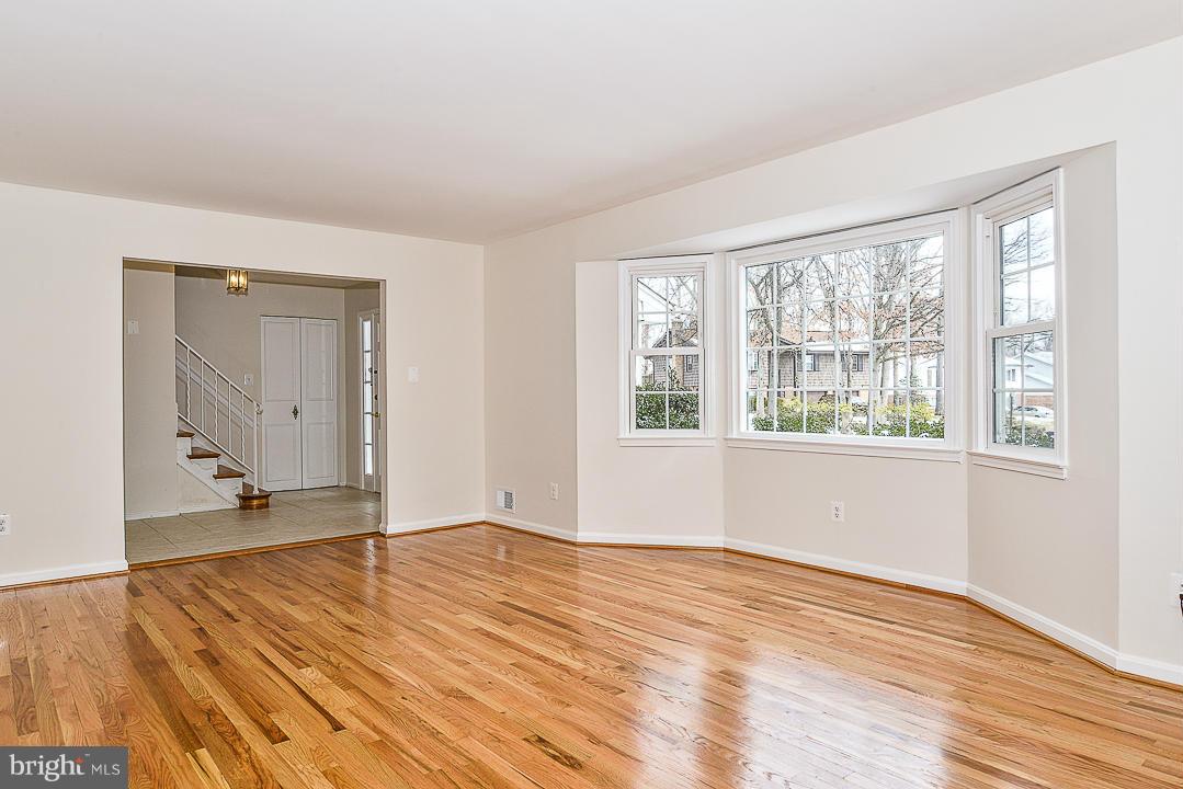 6106 Roxbury Avenue Springfield, VA 22152 - Photo 3 of 29 a view of an empty room with wooden floor and a window