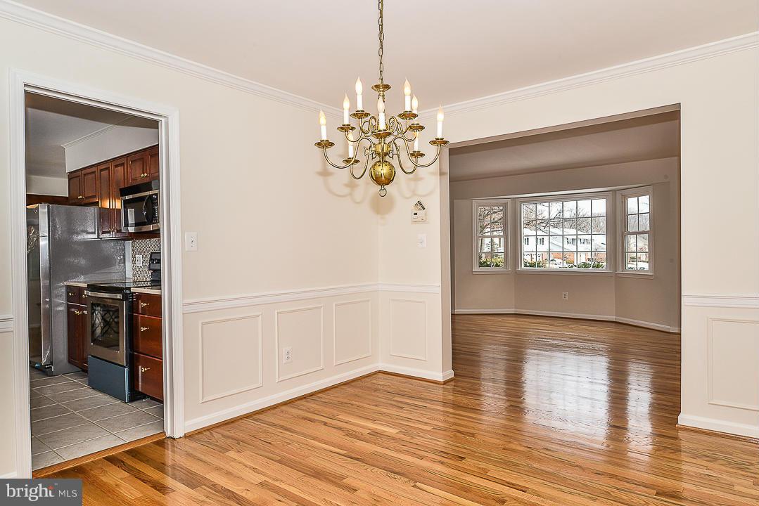 6106 Roxbury Avenue Springfield, VA 22152 - Photo 8 of 29 a view of a hallway with wooden floor and a living room