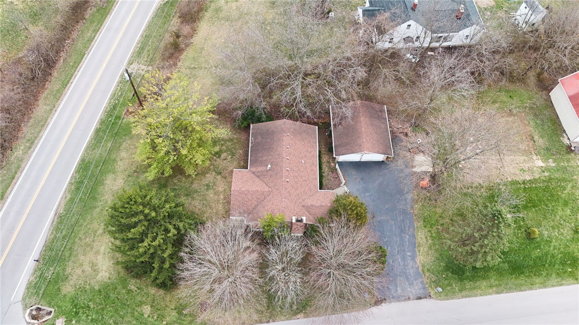 6711 Hamilton-Middletown Road Franklin, OH 45005 - Photo 47 of 49 An aerial view captures a residential property nestled amidst lush greenery with a detached garage.