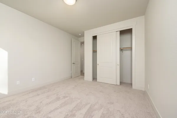 a bedroom with a balcony a bed and wooden floor