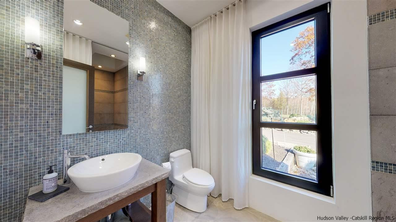 44 Willow Brook Road, Unit 3 799 000 Stanford, NY 12514 - Photo 12 of 18 a bathroom with a toilet sink and mirror