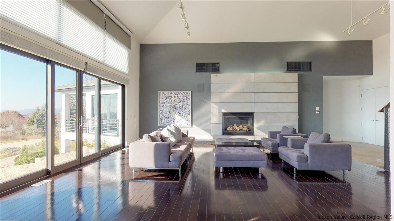44 Willow Brook Road, Unit 3 799 000 Stanford, NY 12514 - Photo 16 of 18 a living room with furniture large window and a fireplace