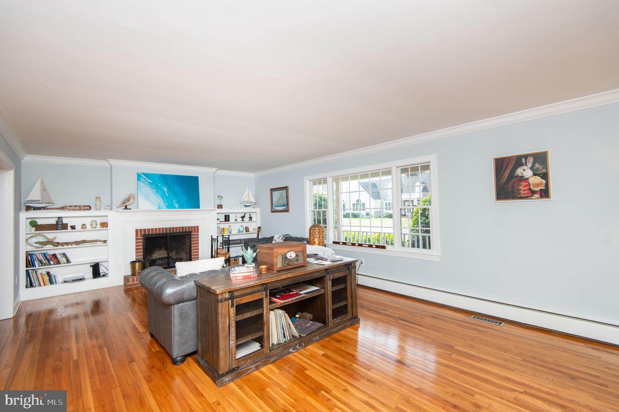 1417 School Street Cambridge, MD 21613 - Photo 11 of 73 a living room with furniture a fireplace and a wooden floor