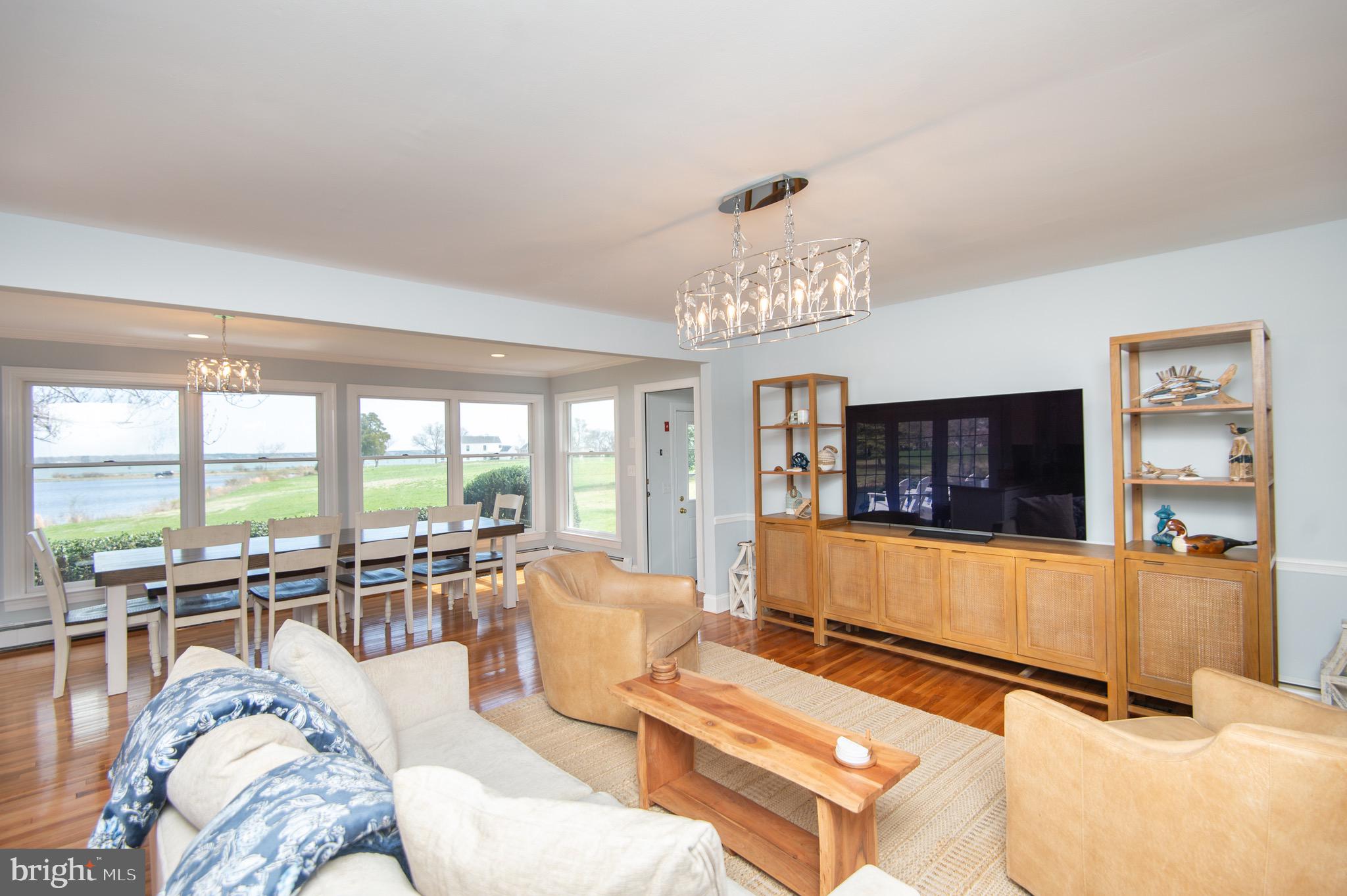 1417 School Street Cambridge, MD 21613 - Photo 16 of 73 a living room with furniture a flat screen tv and a large window