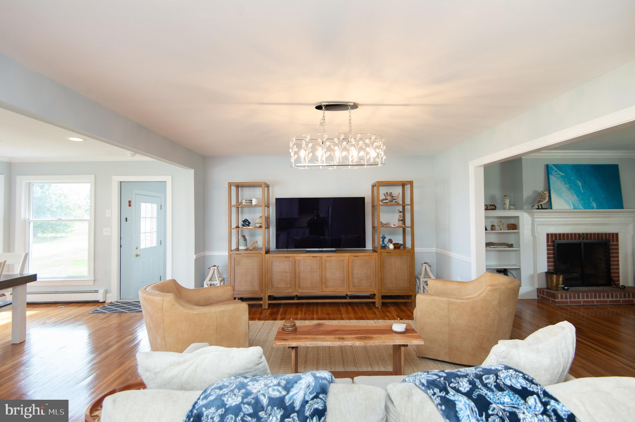 1417 School Street Cambridge, MD 21613 - Photo 17 of 73 a living room with furniture a flat screen tv and a fireplace