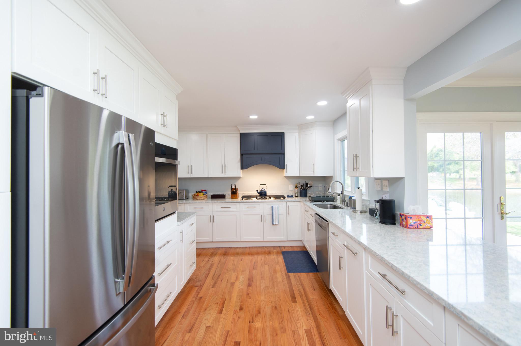 1417 School Street Cambridge, MD 21613 - Photo 26 of 73 a large kitchen with stainless steel appliances and refrigerator